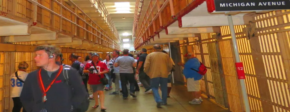 visit_alcatraz_prison_cell_block_tourists_walking_by_inmates_cells_gallery